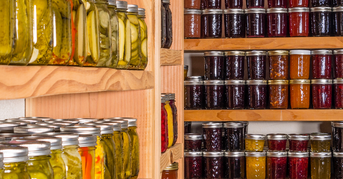 A pantry full of home-canned goods in glass jars.